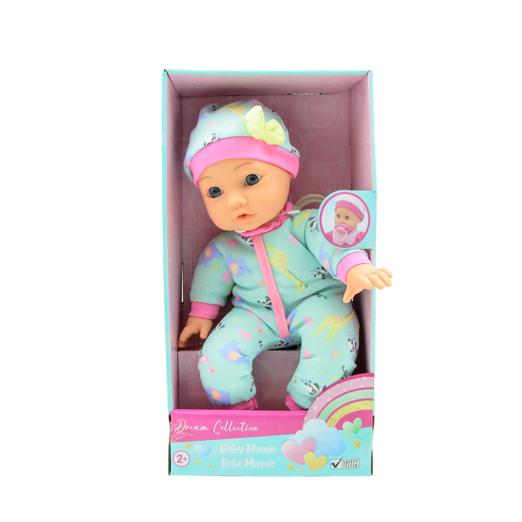 A baby doll in a blue and pink outfit with a bottle and a plush animal, packaged in a box with 'Dream Collection' branding.
