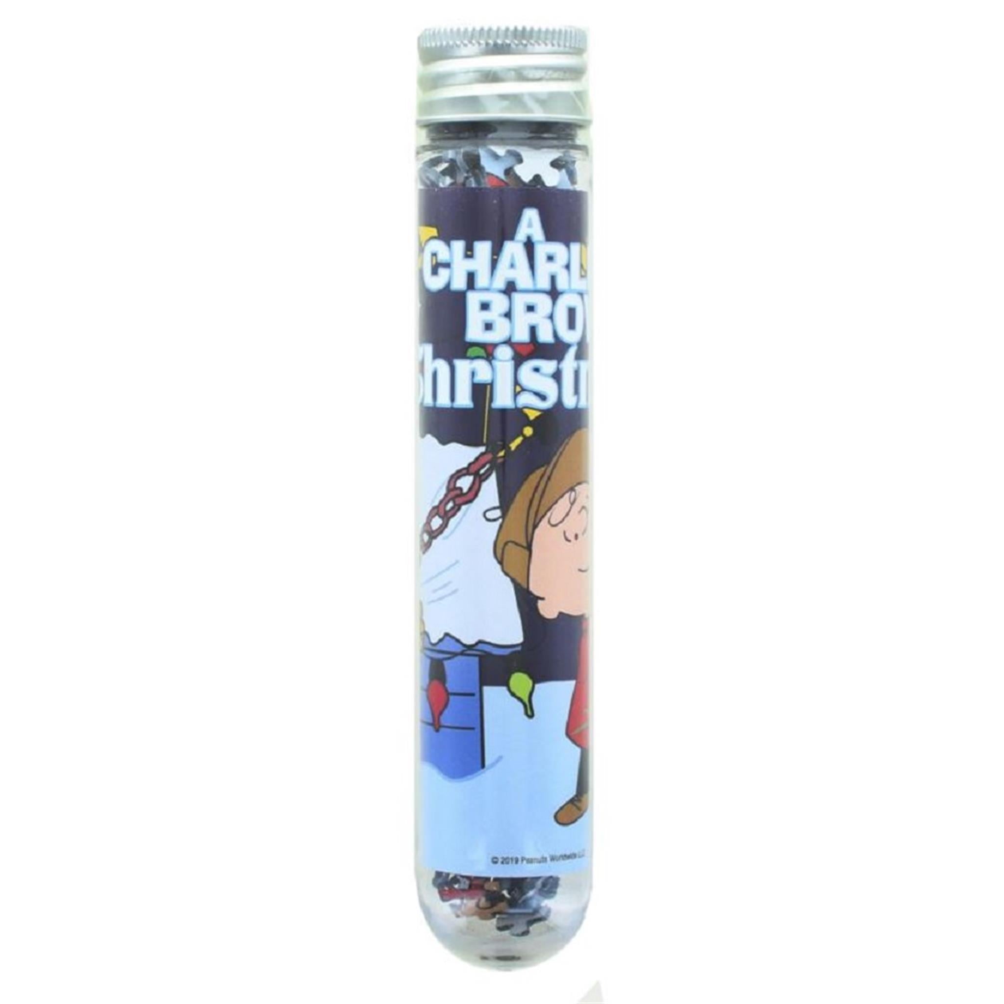 Charlie Brown Christmas themed micro puzzle in a plastic test tube packaging with an illustration of Charlie Brown and a Christmas tree on the label.