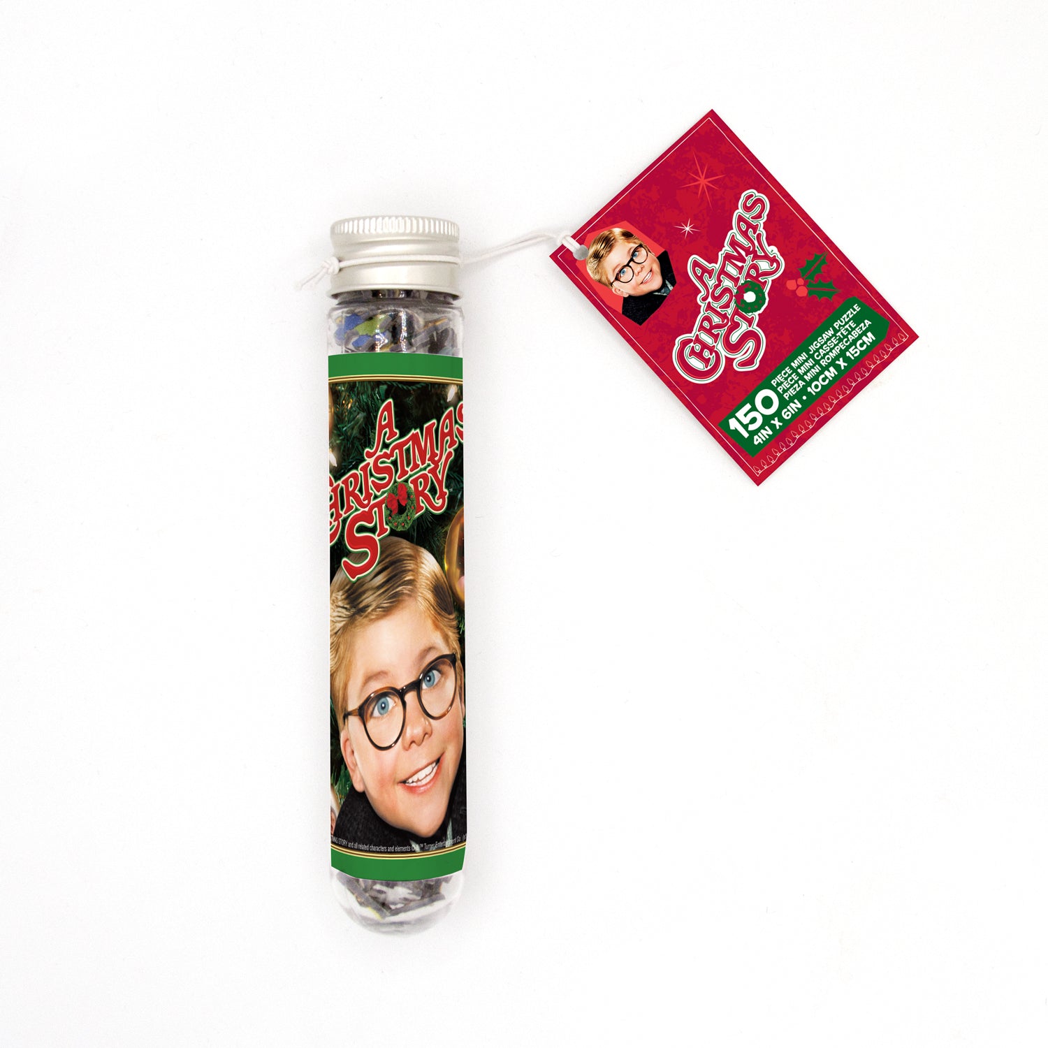A Christmas Story themed micro jigsaw puzzle in a tube, featuring an image of Ralphie with glasses in front of a Christmas tree, with packaging displaying the same image and product details.