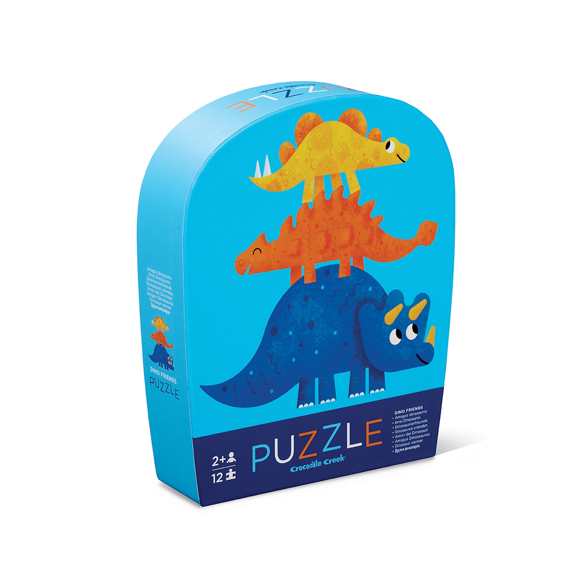 A packaged 12-piece jigsaw puzzle featuring colorful dinosaur shapes, with the product name 'Puzzle' visible on the curved blue box.