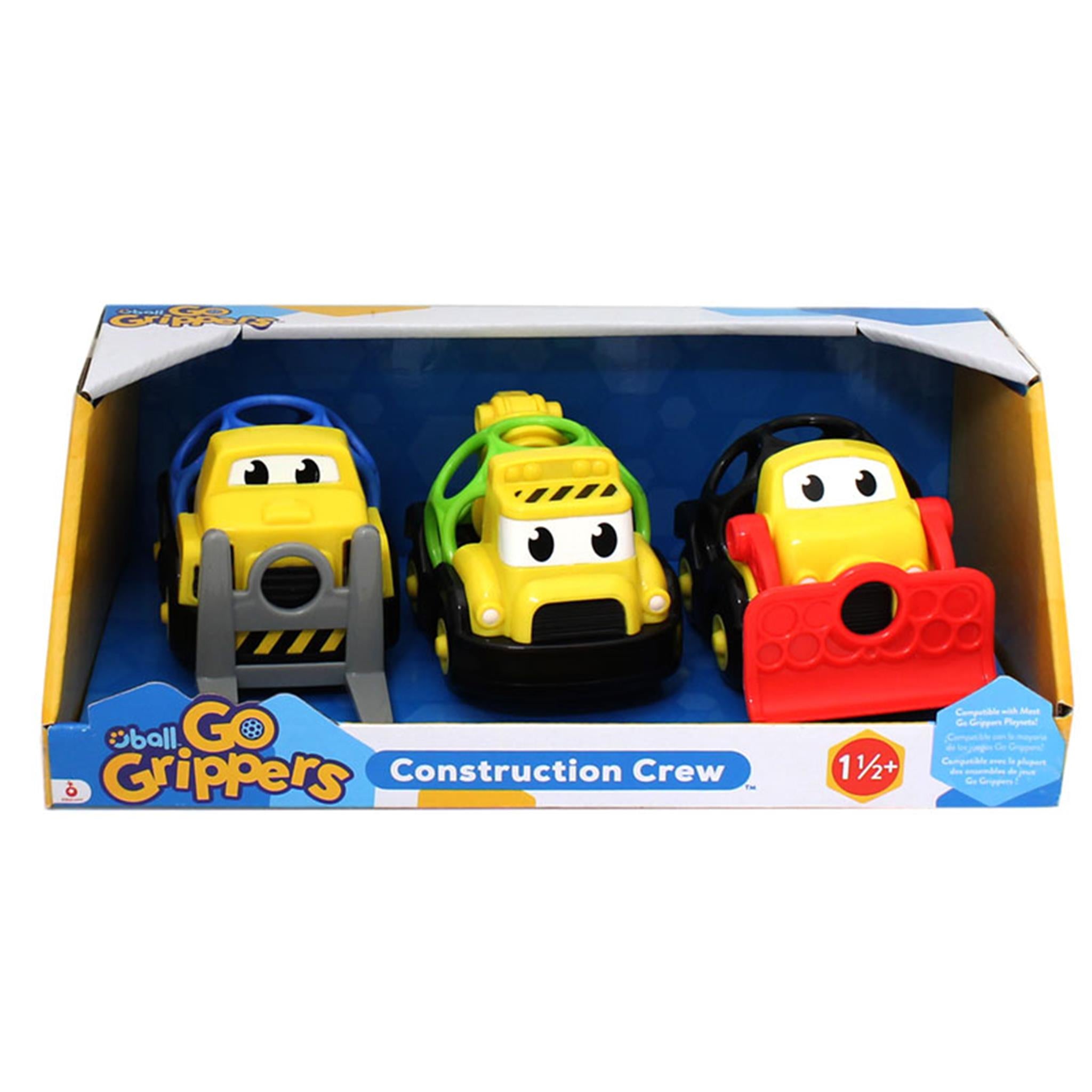 A set of three colorful toy trucks in packaging, labeled as 'Go Grippers Construction Crew'. The set includes a yellow backhoe, green front loader, and red fork truck.
