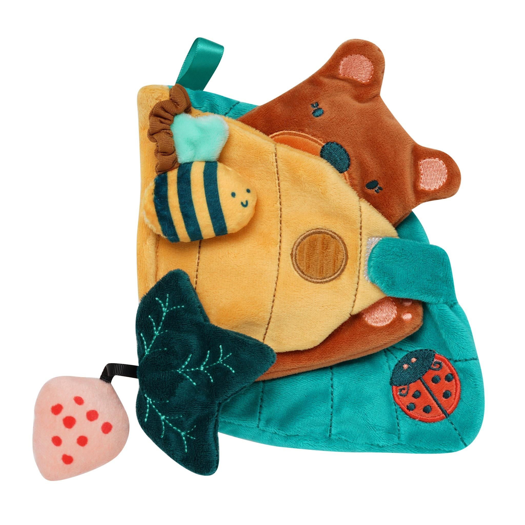 A soft sensory book for babies with various textures and designs, including a bee, a bear, and a strawberry, on a blue background.