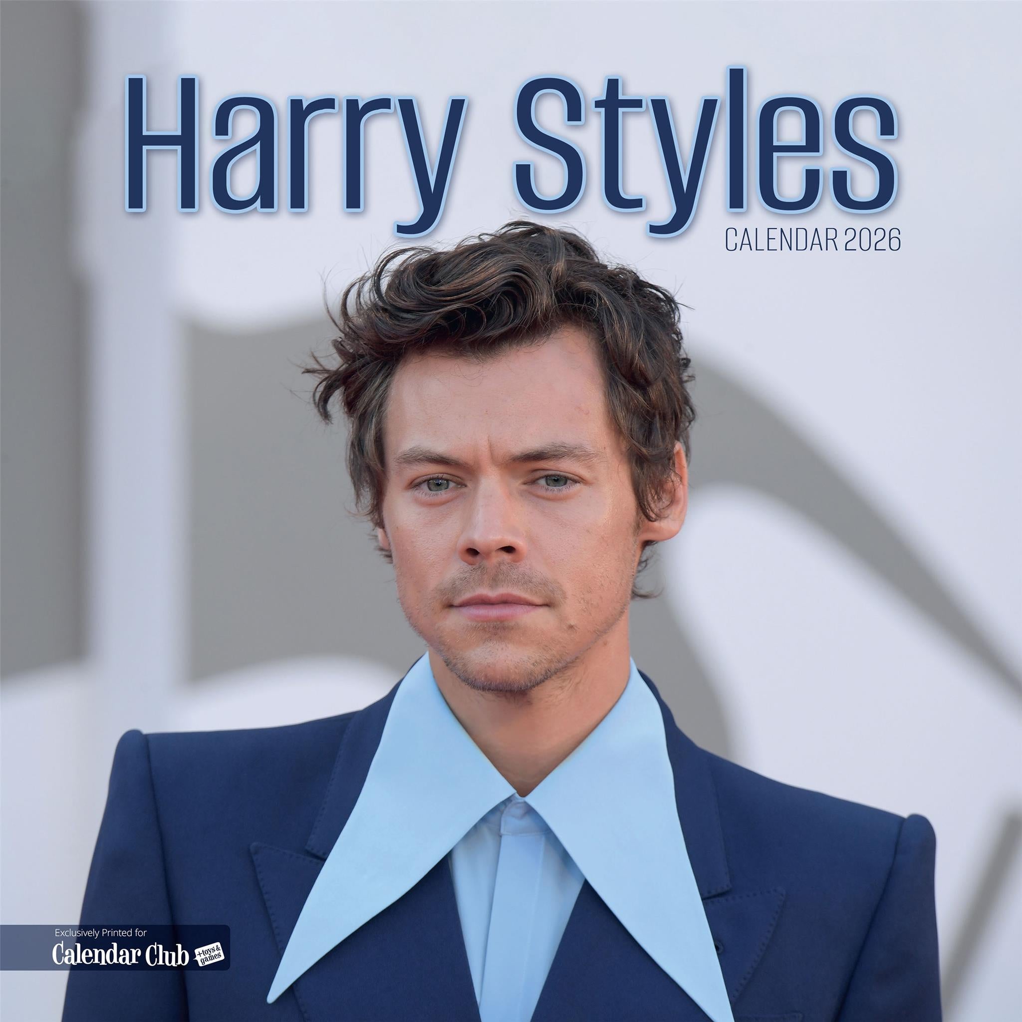 Harry Styles calendar cover with Harry posing for the camera in a blue suit and oversized shirt collar.