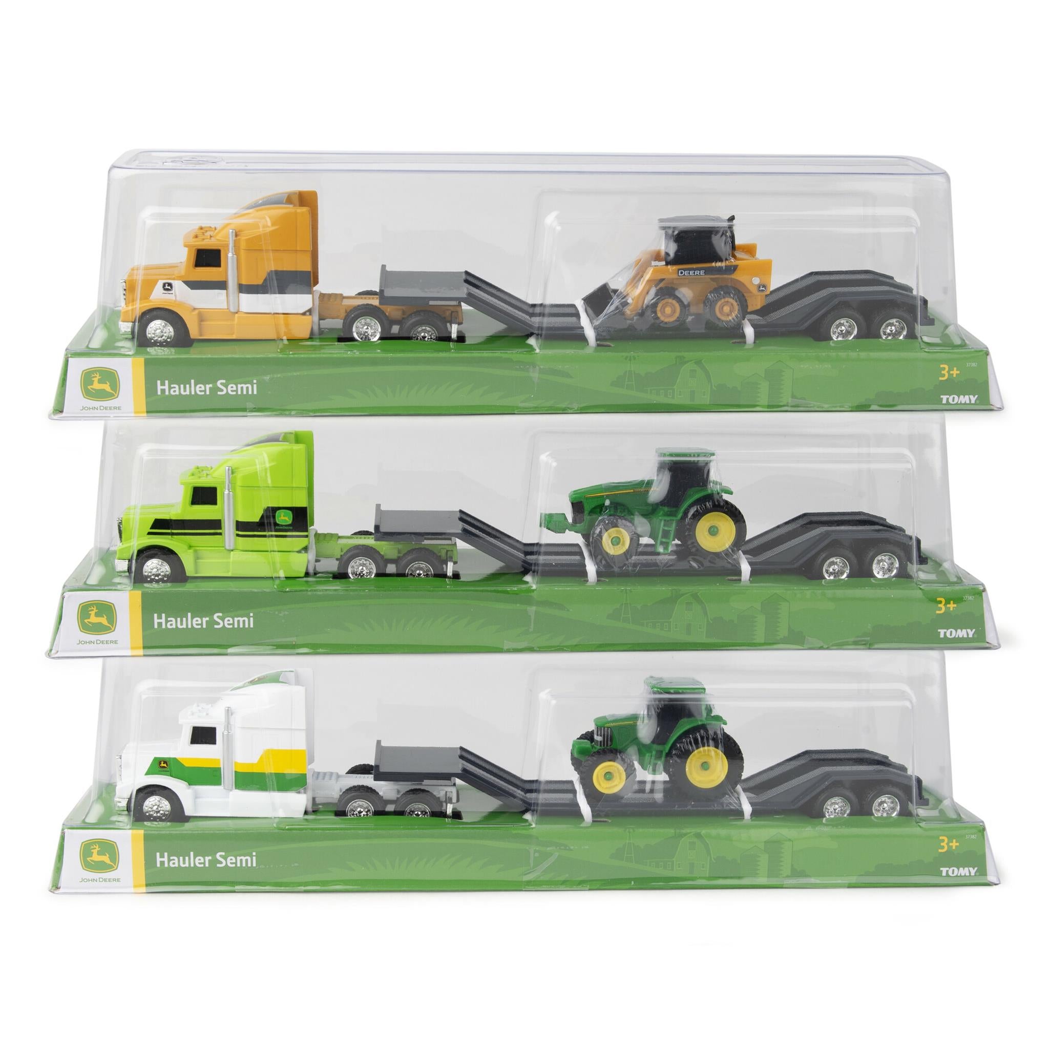 Three packaged John Deere toy vehicles including a semi and a tractor, displayed in their clear packaging.