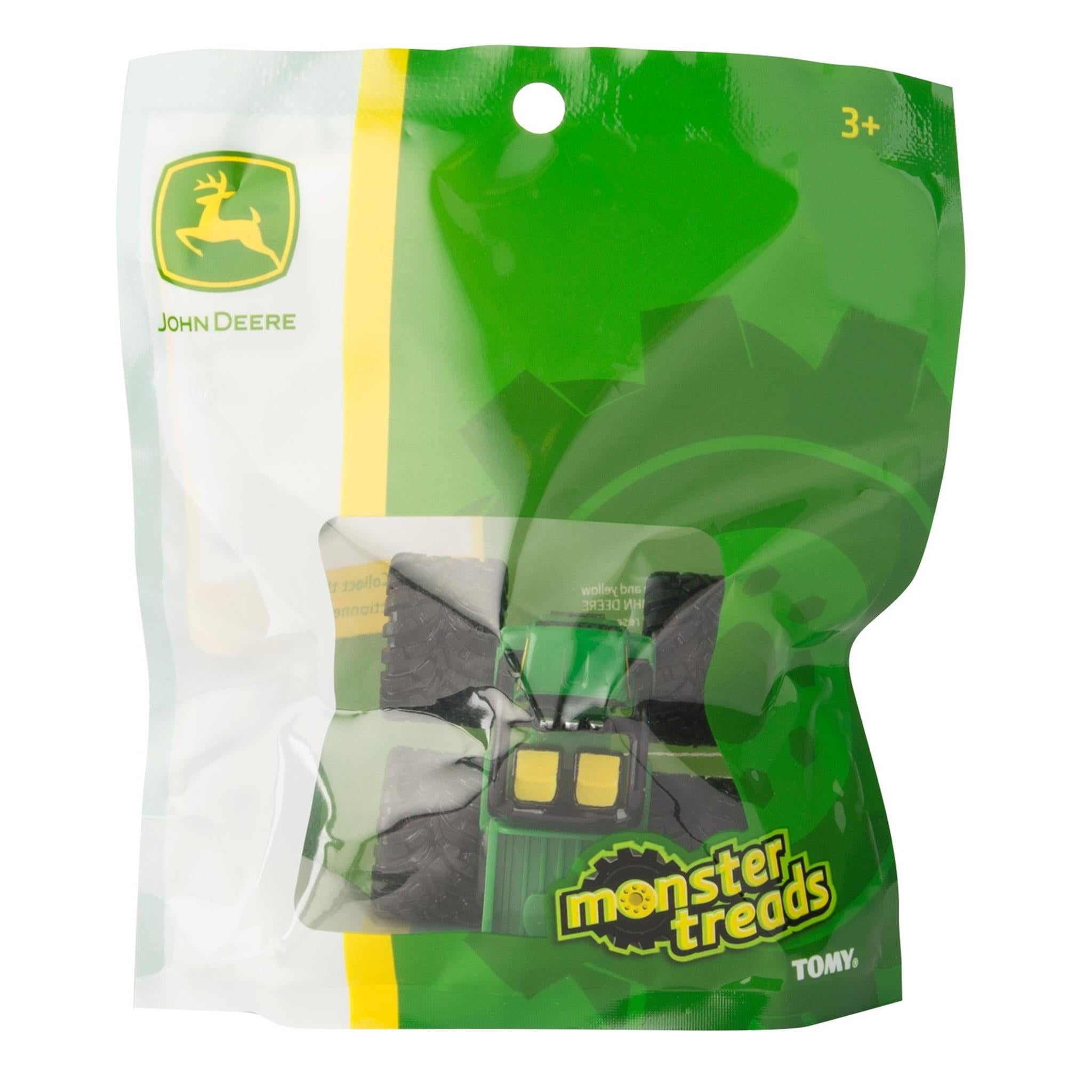 Packaged Monster Treads toy vehicle resembling a tractor in green and yellow colors with John Deere branding on the packaging.