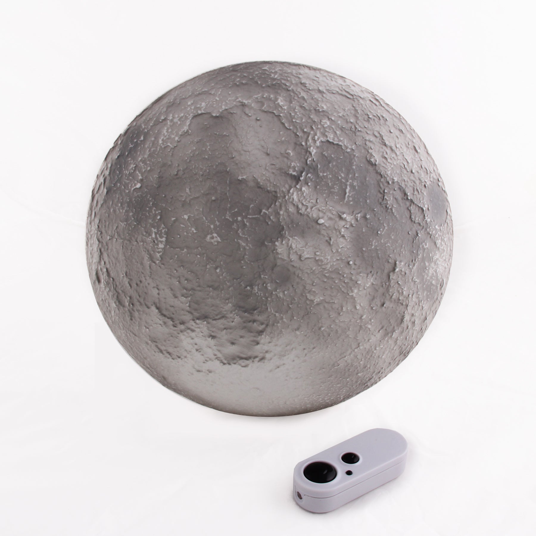 A wall-mounted moon-shaped lamp with a remote control, featuring different light-up lunar phases.