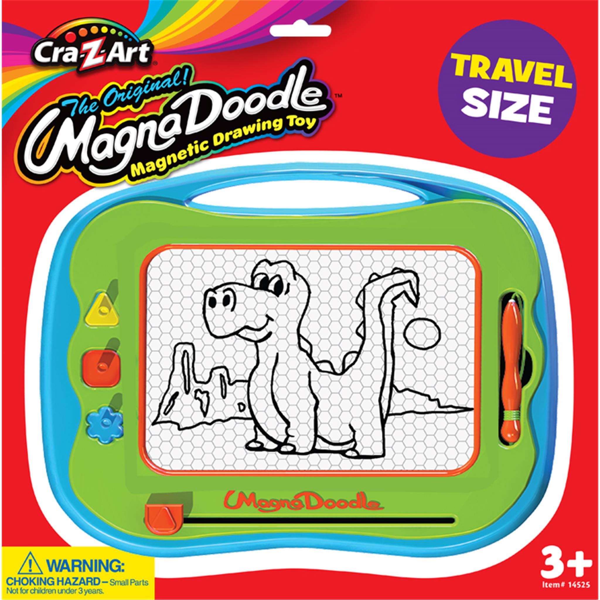 The image shows a travel-sized Magna Doodle drawing toy with a green frame. It includes a magnetic pen and three stampers, with a dinosaur and a robot drawn using the magnetic drawing technique.