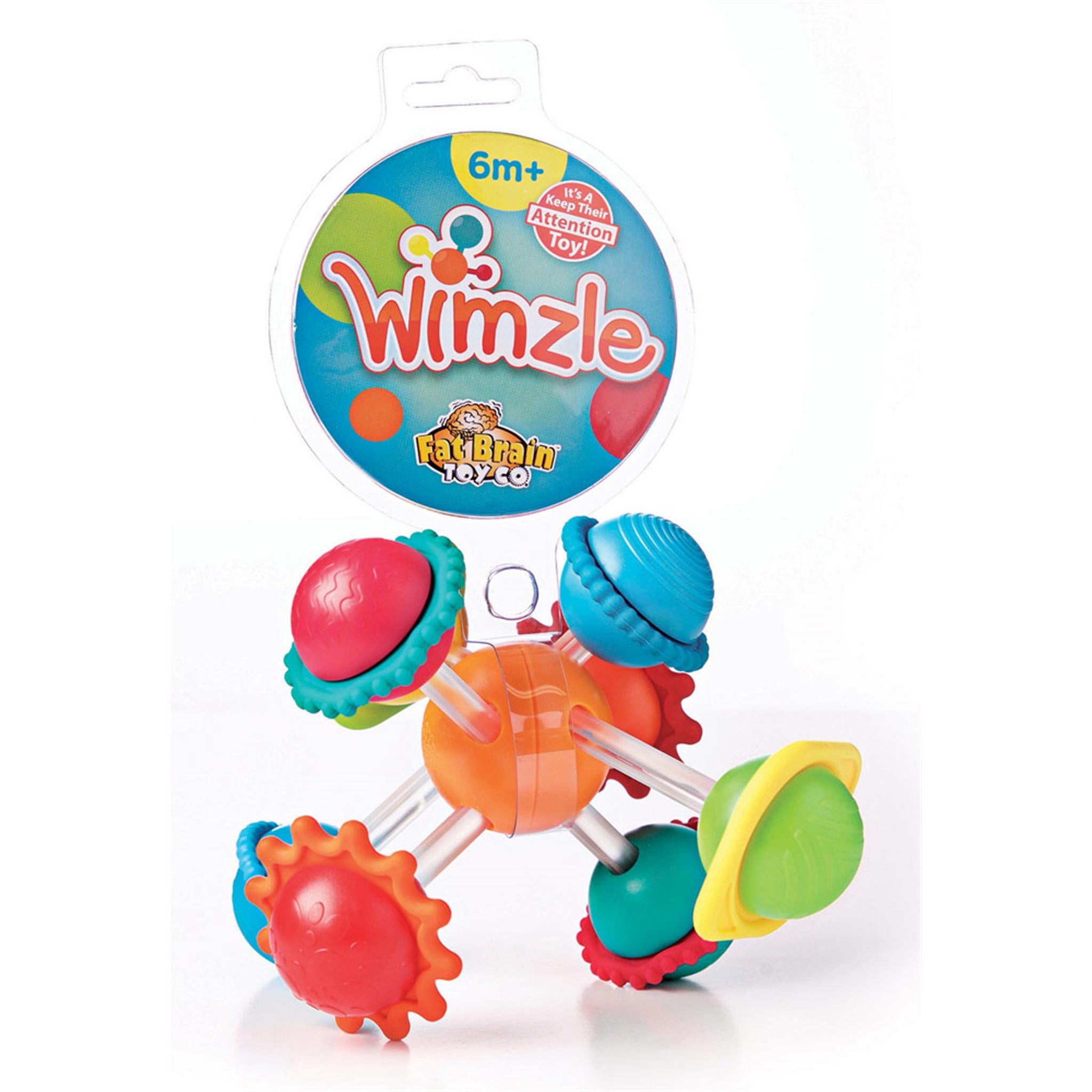 A colorful Wimzle toy made up of a central ball with four bars and textured spinning spheres, packaged with a '6m+' age recommendation.