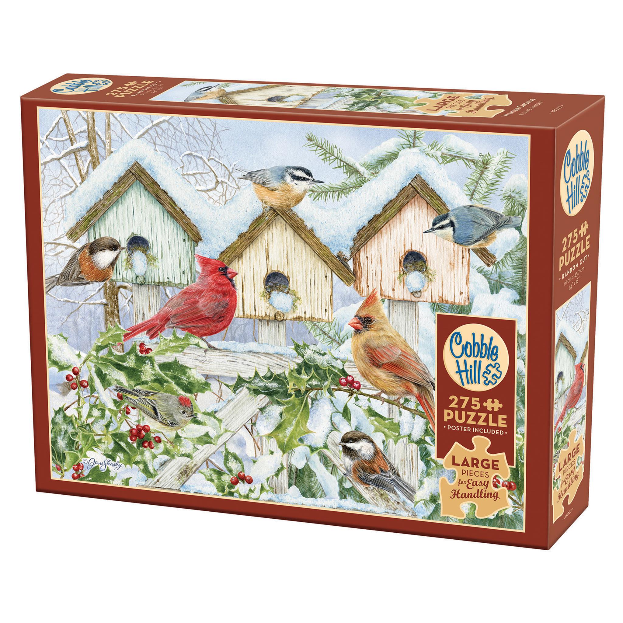 A puzzle box featuring an illustrated winter scene with birds gathered around birdhouses, with a red cardinal prominent in the image.