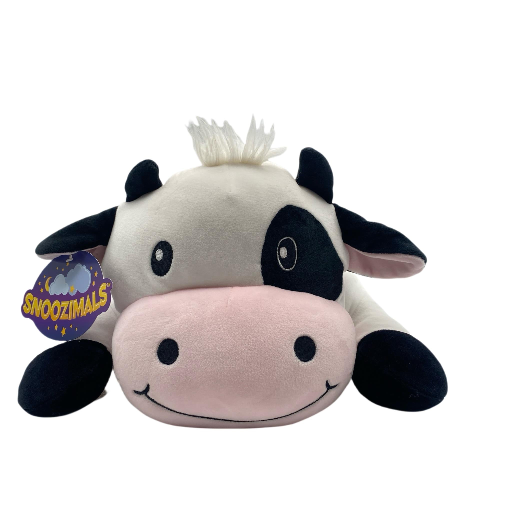 A plush toy resembling a black and white cow with a pink nose, part of the Snoozimals collection.