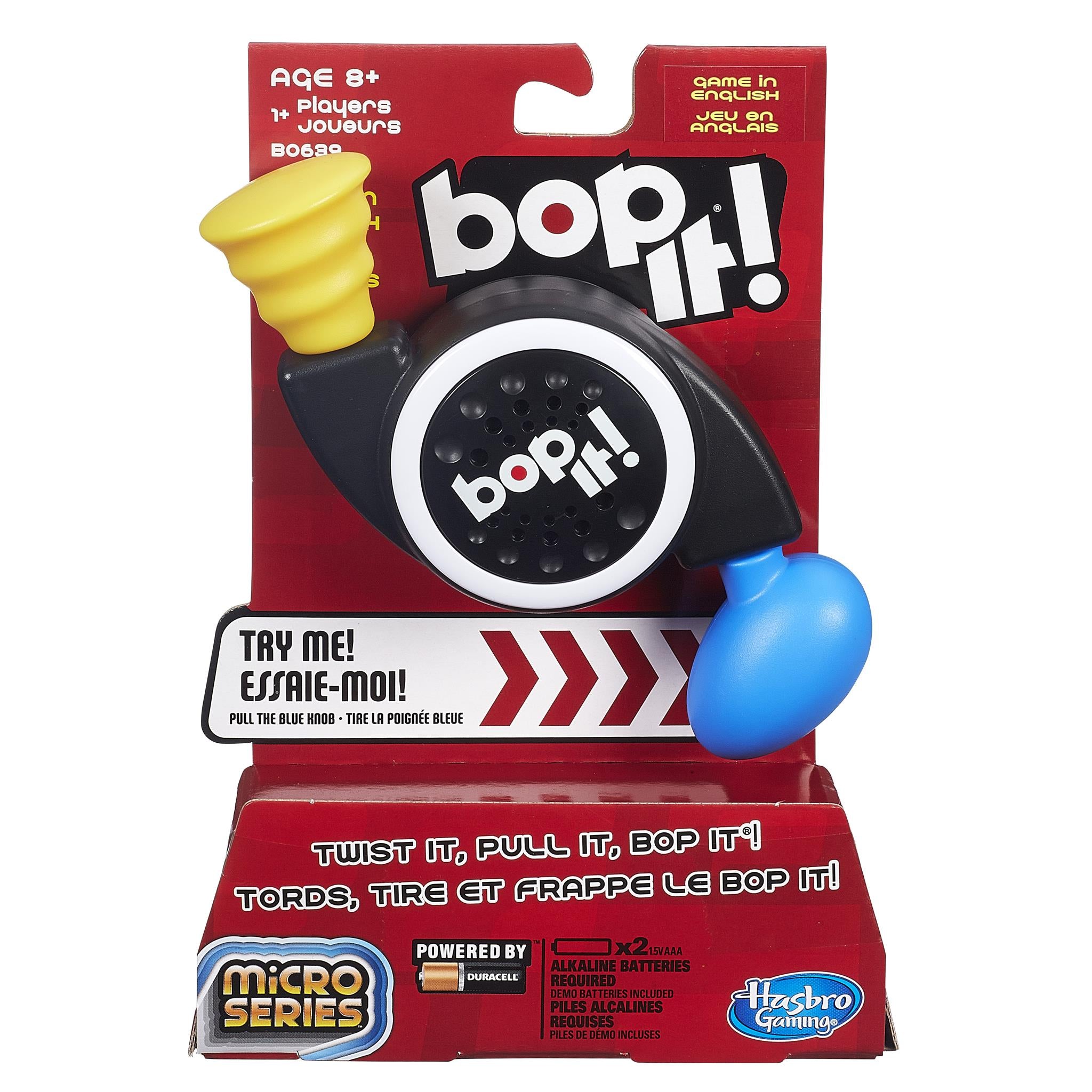 Bop It! Micro Series handheld electronic game packaging, featuring the game's black and blue colored unit along with 'Try me!' and 'No batteries required' labels.