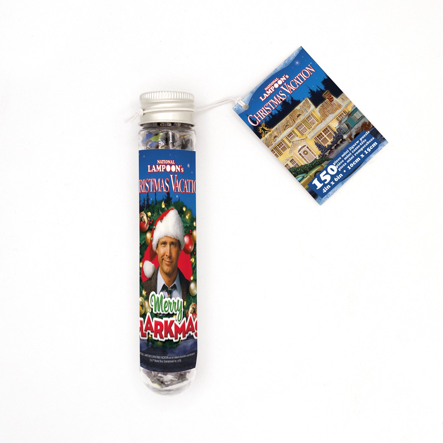 A packaged Christmas Vacation themed micro jigsaw puzzle in a tube, featuring an image of Clark Griswold in a Santa hat with a Christmas wreath.