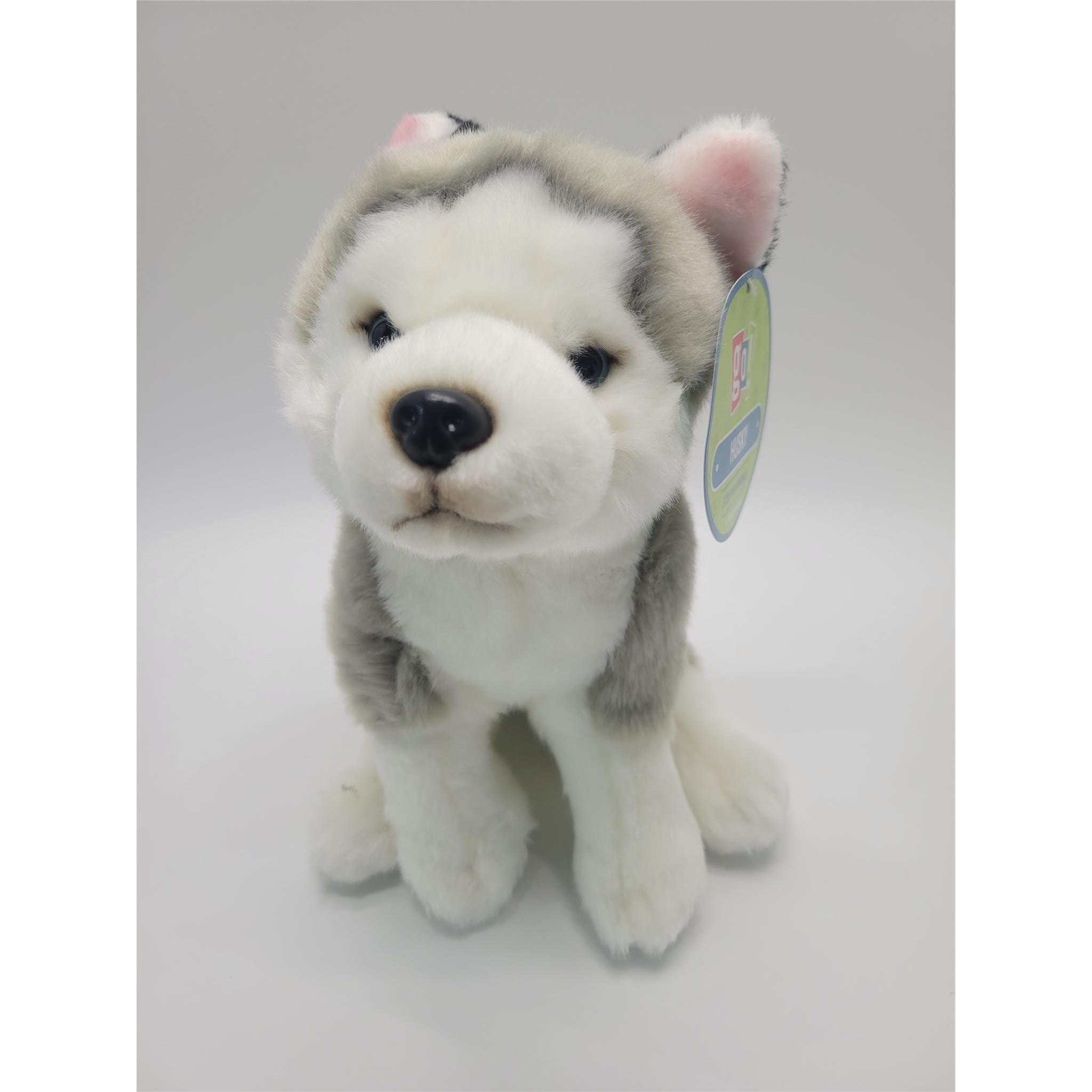 White and grey plush husky stuffed animal. Pink inner ears with plastic eyes and nose. 