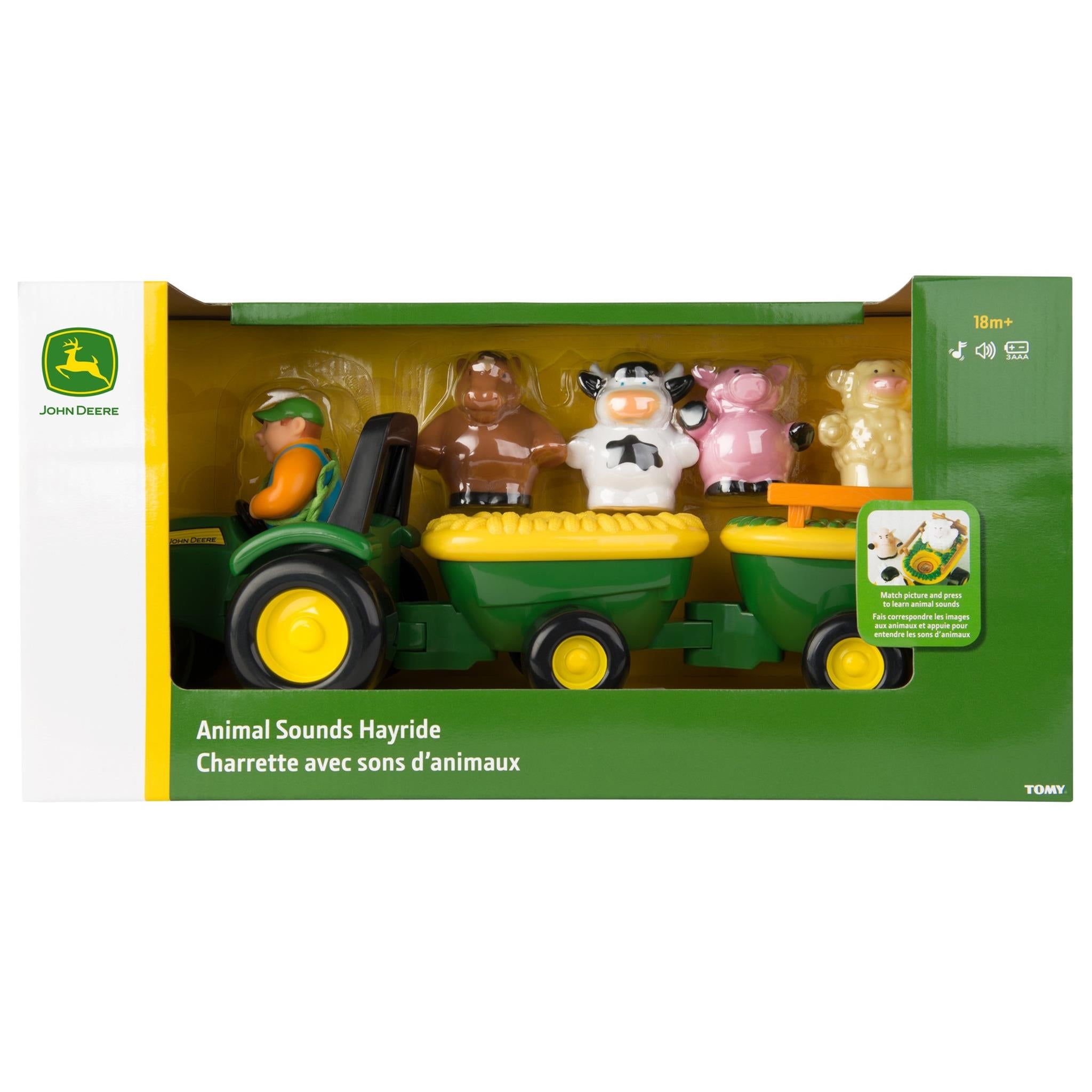 John Deere Animal Sounds Hayride toy set in packaging, featuring a green tractor, farm animals, and a yellow wagon.