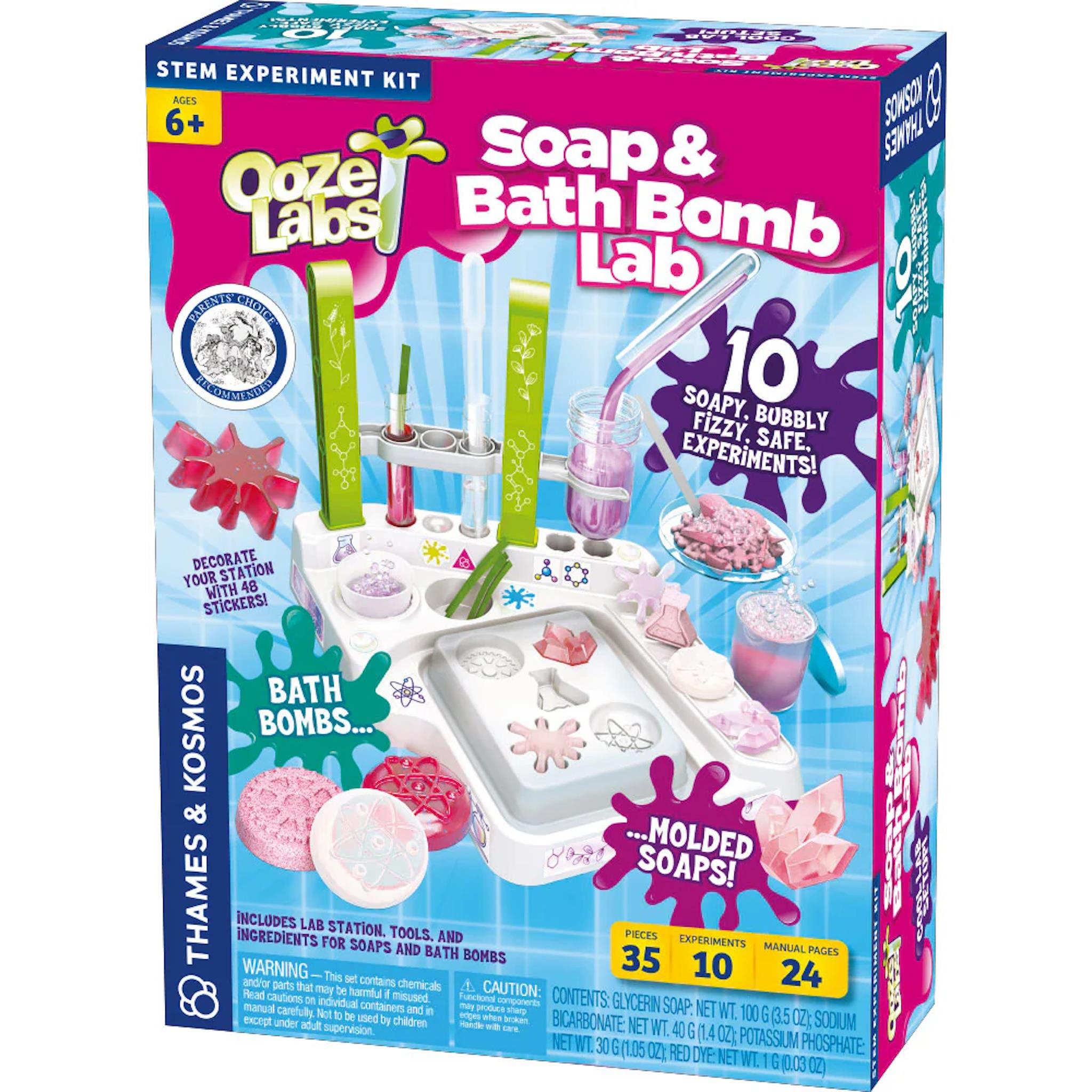 Packaging for Ooze Labs Soap & Bath Bomb Lab kit, featuring images of the lab equipment and bath bombs, with a pink background.