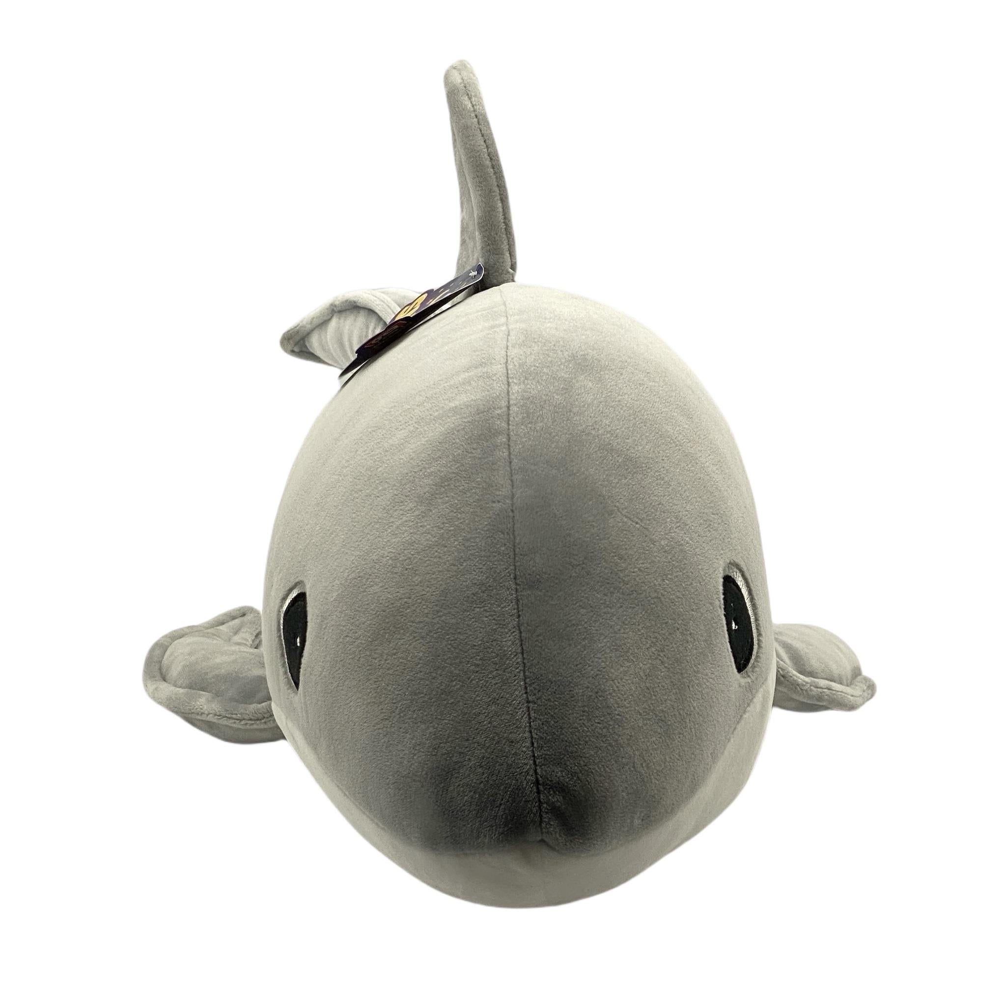A plush toy resembling a shark, with a gray body and lighter gray accents, designed to be cuddly and soft.