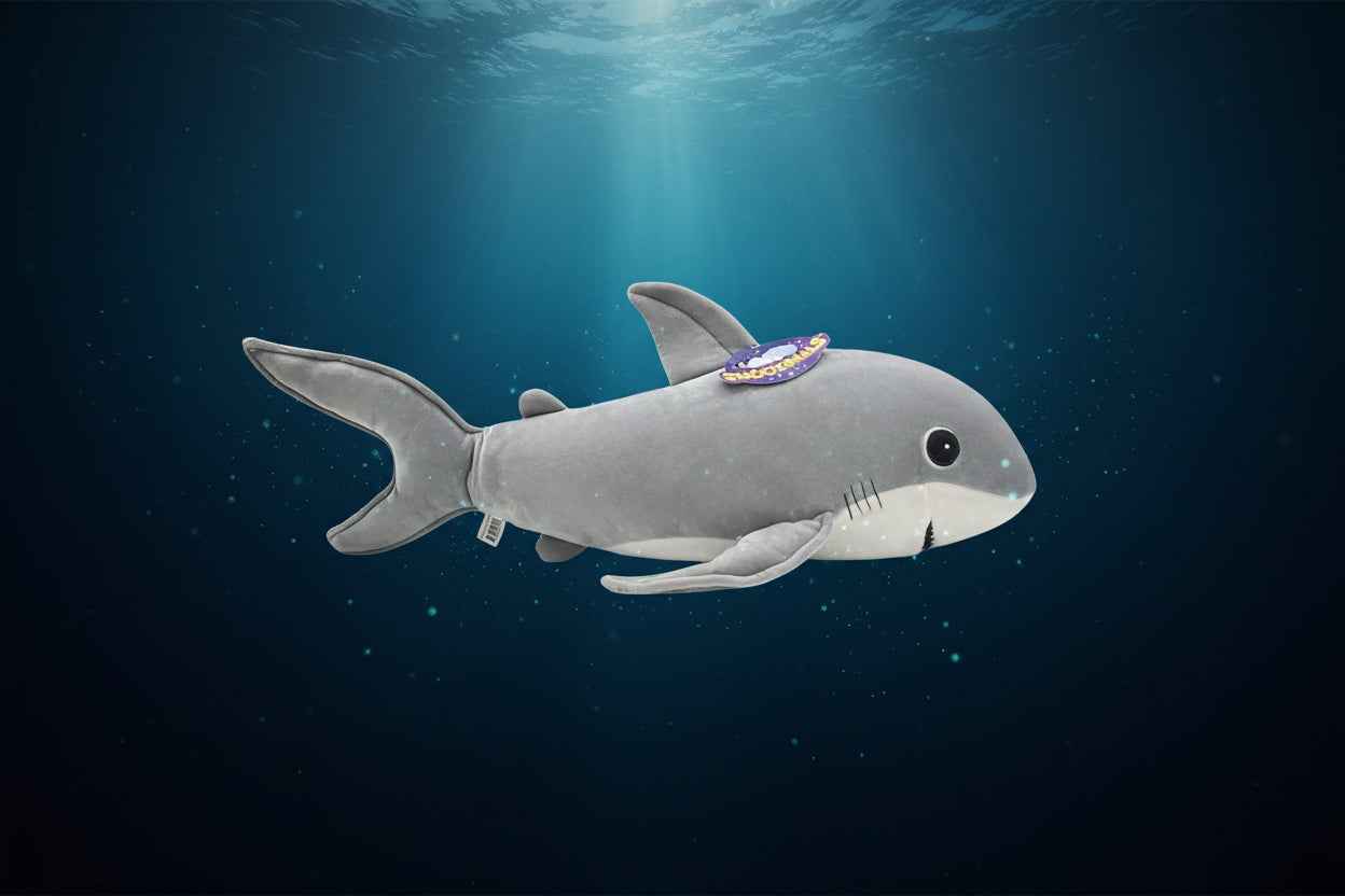 Plush shark toy  on a dark blue underwater background