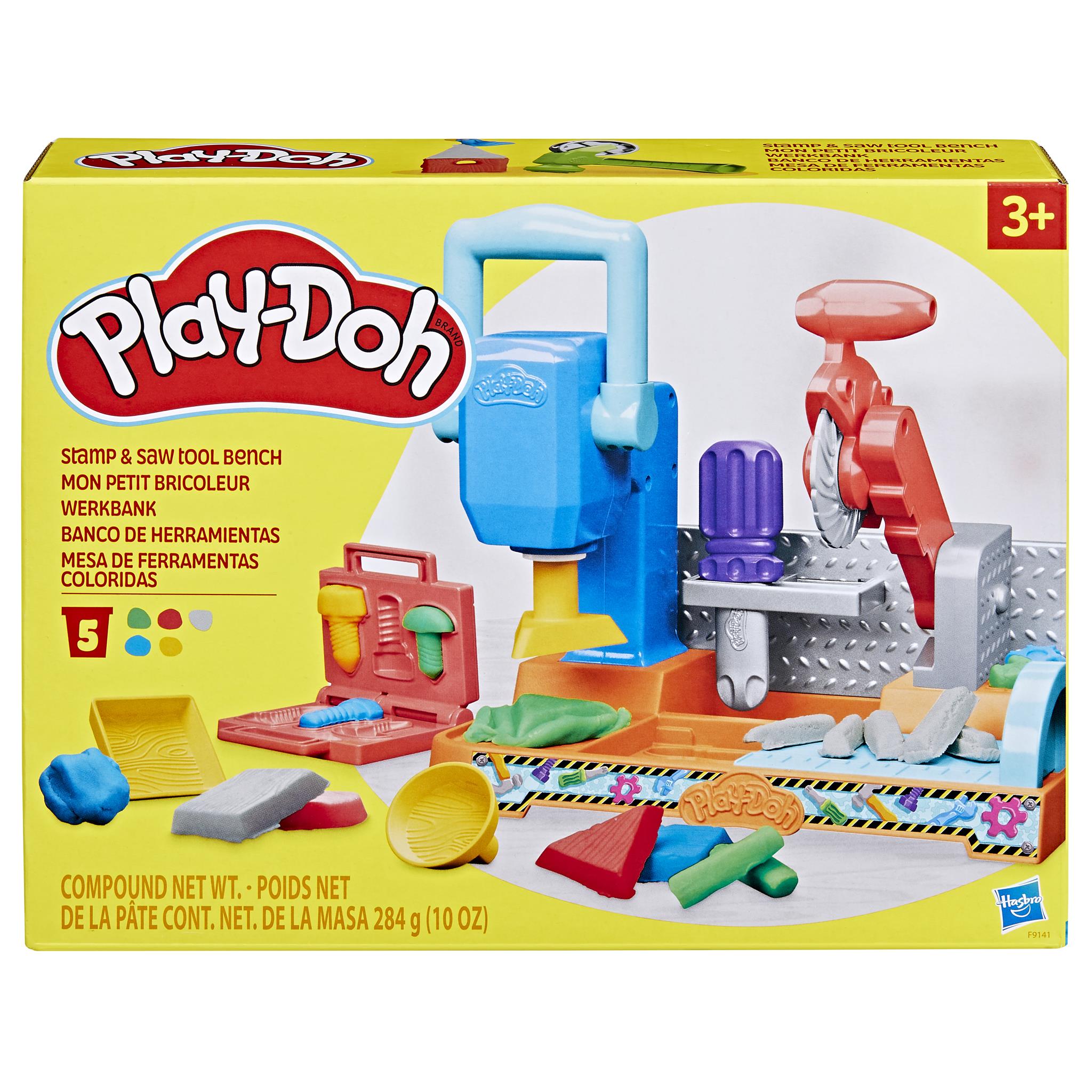 Packaging for the Play-Doh Stamp N Saw Workbench toy, featuring the toy set with various Play-Doh tools and colors.