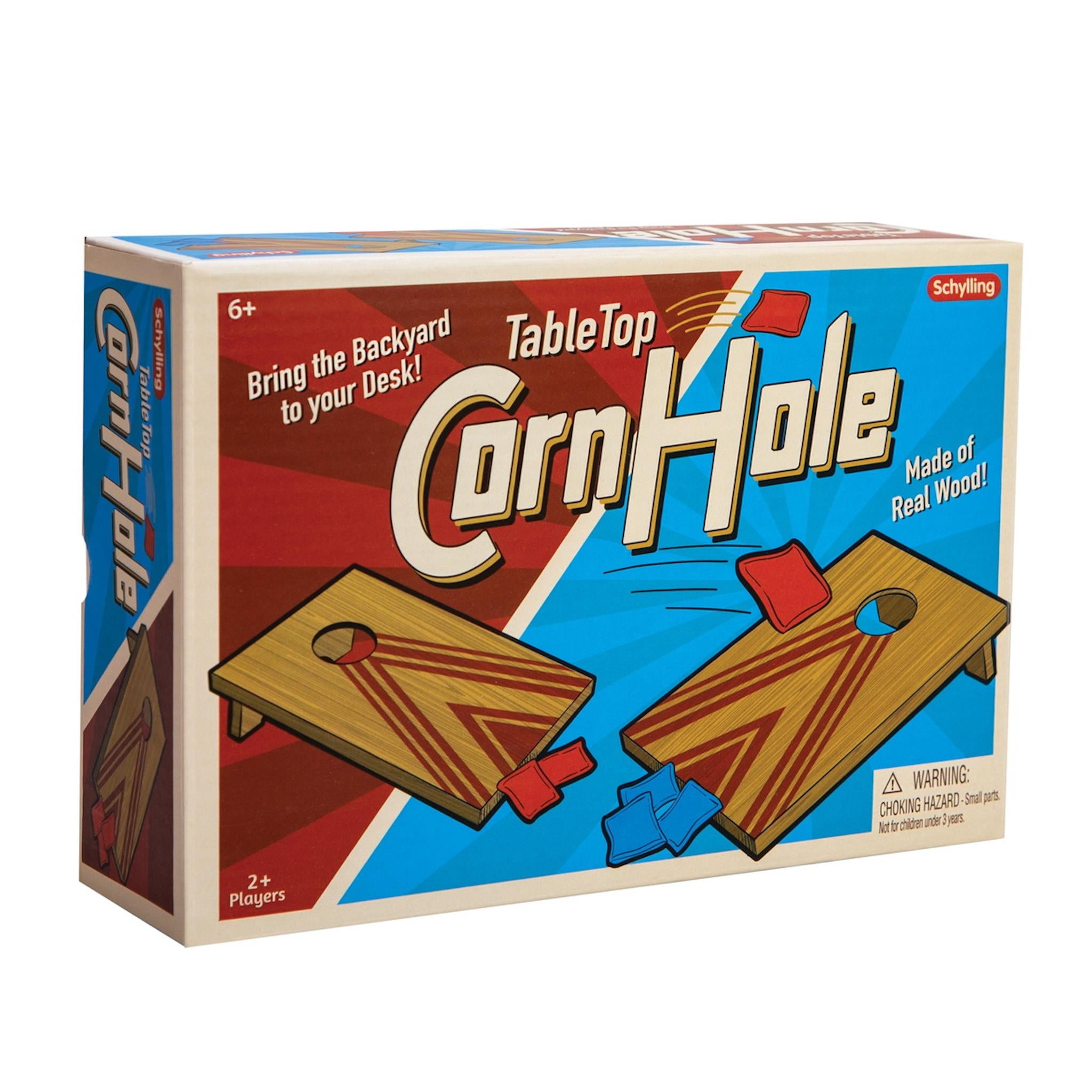 A product image featuring the packaging for Table Top Corn Hole by Schylling, depicting the game with bean bags and the text 'Bring the backyard to your desk!'.