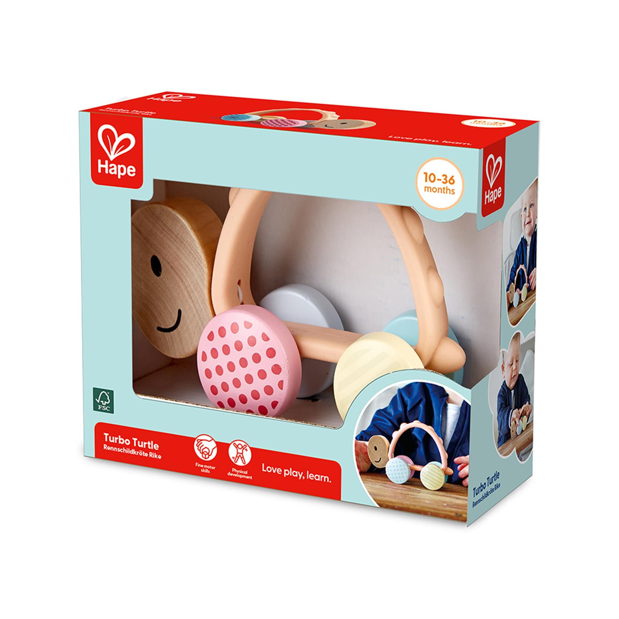 Packaged 'Turbo Turtle' toy featuring a wooden turtle with colorful patterned wheels and a silicone handle, displayed in a box with 'Hape' branding.