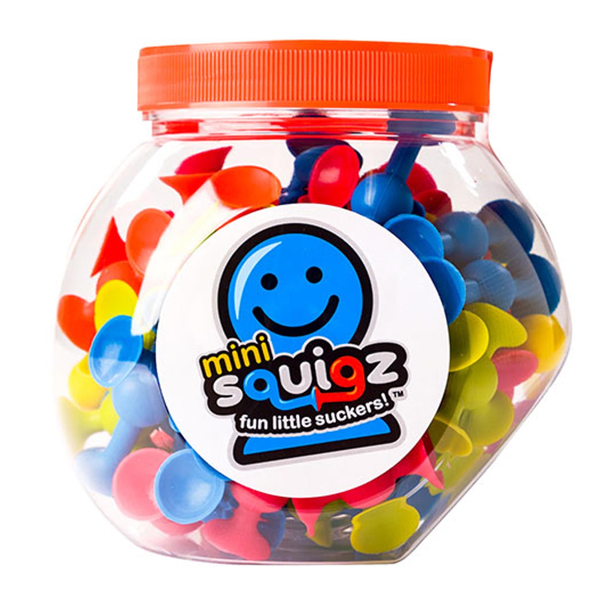 A clear plastic container filled with multicolored spherical building toys, known as miniSquigz, with a red lid and a label featuring a smiling face and the product name.